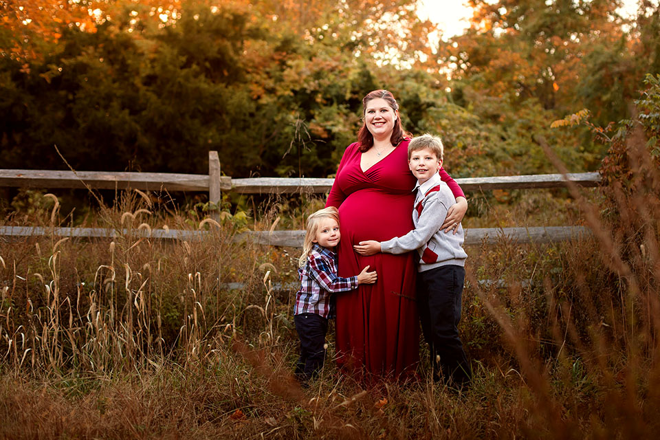 Pregnant woman taking photos with family