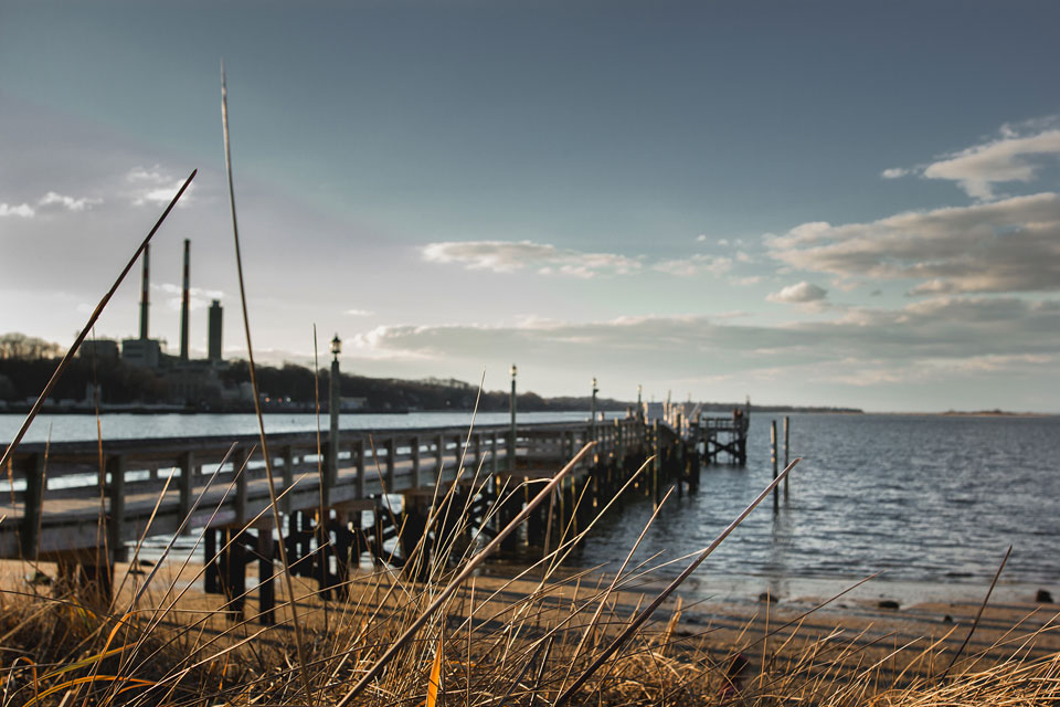 women writers working on the beach in front of a Port Jefferson New York pier
