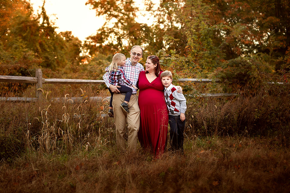 Pregnant woman taking photos with family