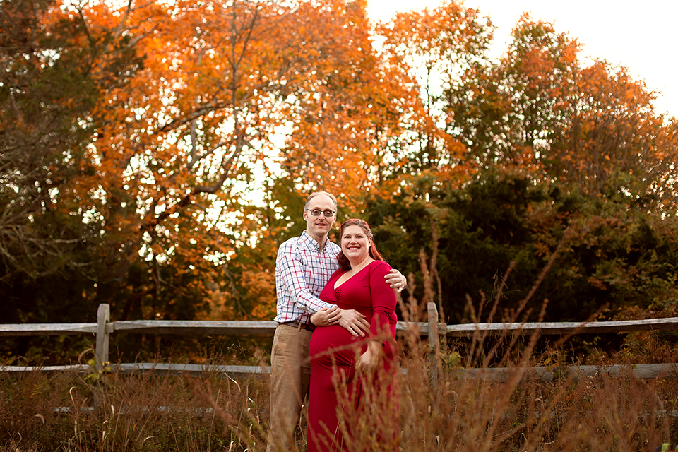 Pregnant woman taking photos with family
