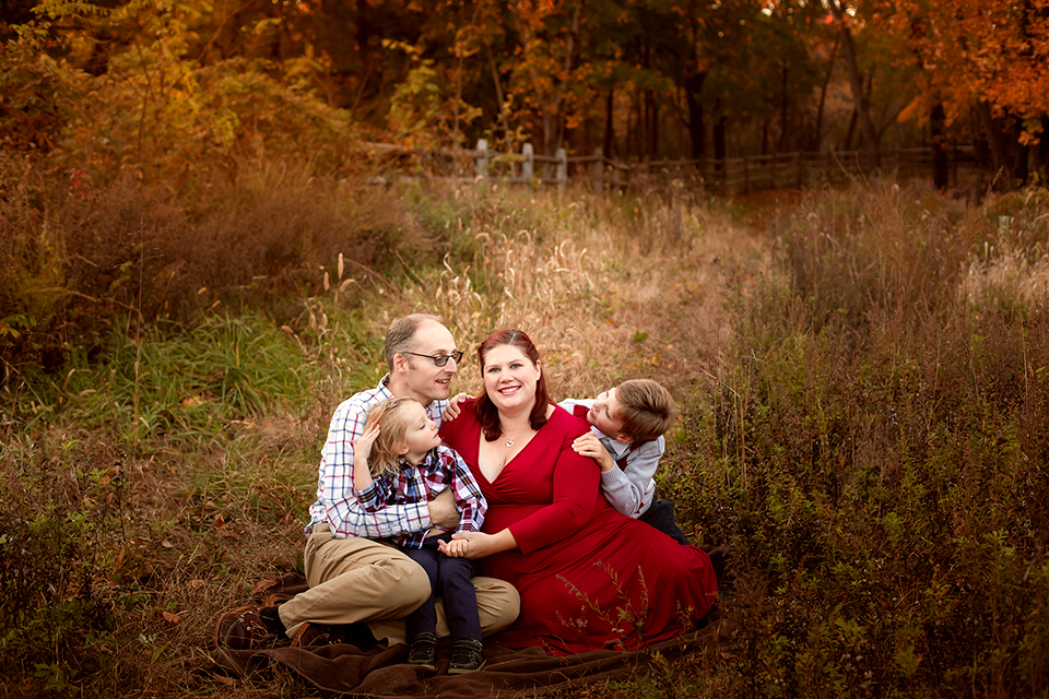 Pregnant woman taking photos with family