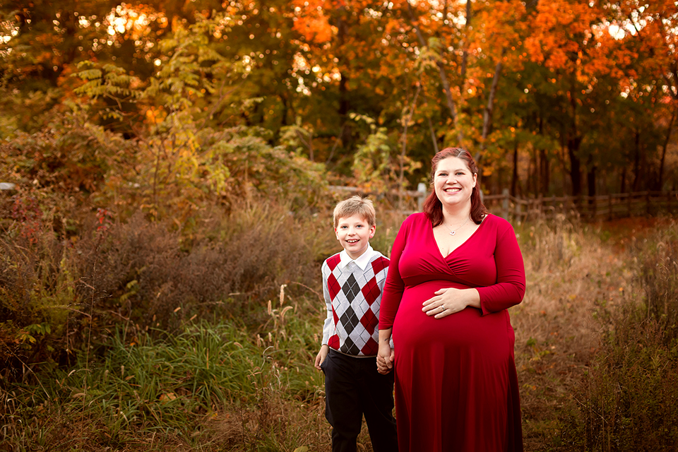 Pregnant woman taking photos with family